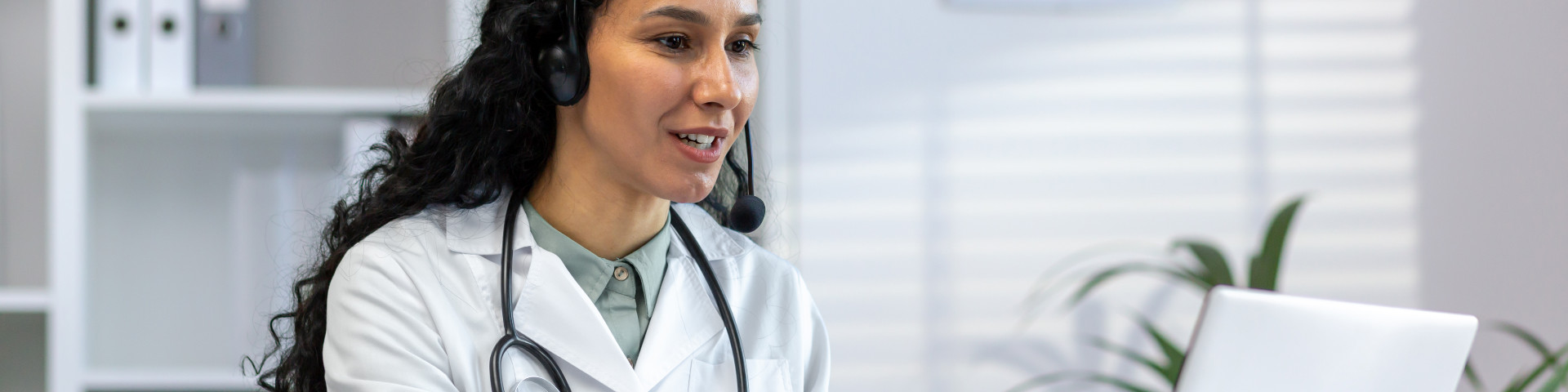 female doctor working inside medical office at desk