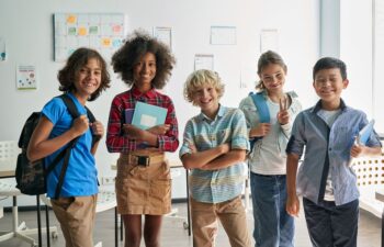 A multicultural group of school kids in a classroom